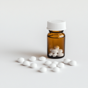 white_round_pills_and_a_bottle_white_background_