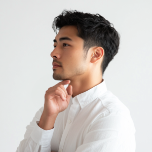 Japanese_man_touching_his_chin_considerng_wearing_white_shirt