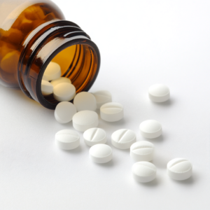 white_round_pills_and_a_bottle_white_background_